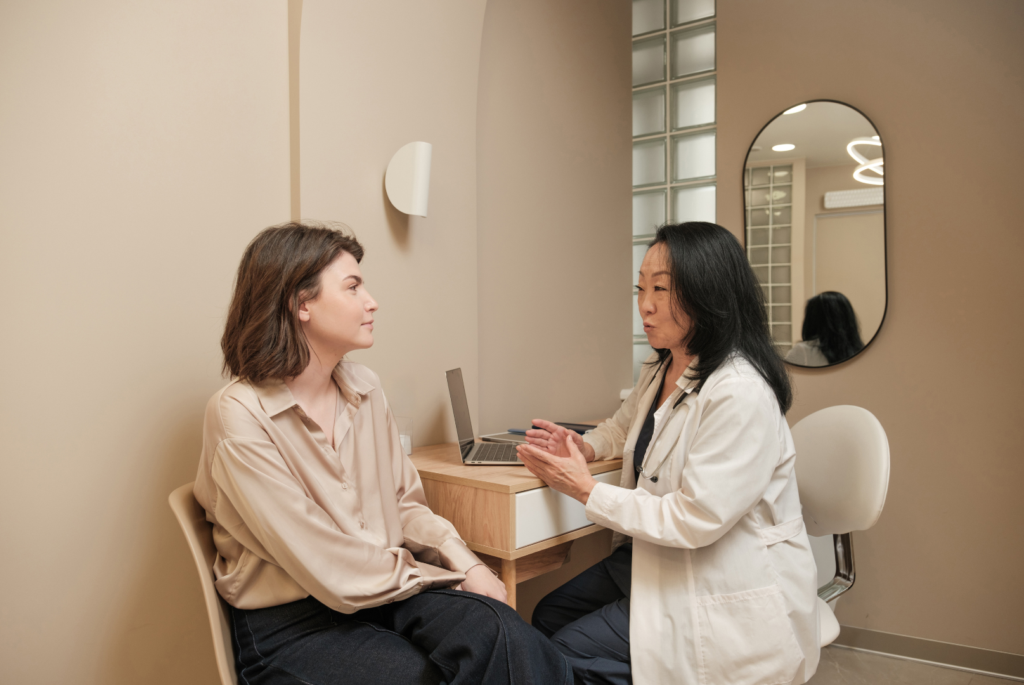 A doctor is talking to a patient in a medical office. Preventive care discussion.